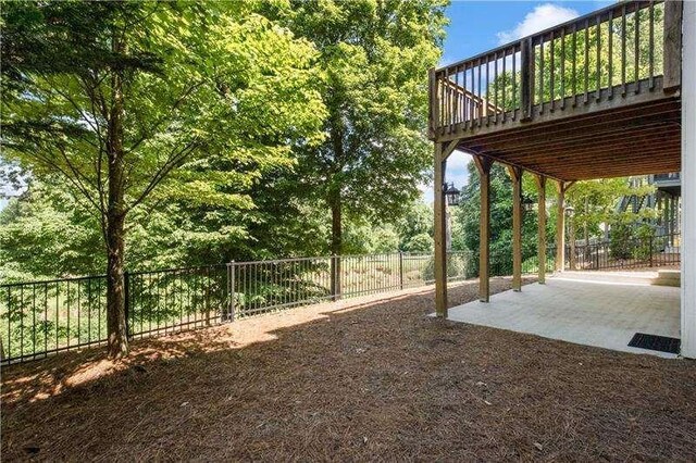 view of yard with a deck and a patio area