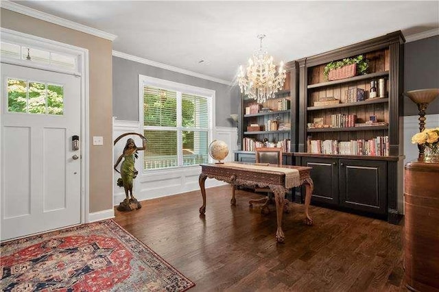 interior space with built in shelves, crown molding, dark wood-type flooring, and a notable chandelier