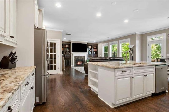 kitchen featuring white cabinetry, light stone counters, dark hardwood / wood-style floors, appliances with stainless steel finishes, and ornamental molding