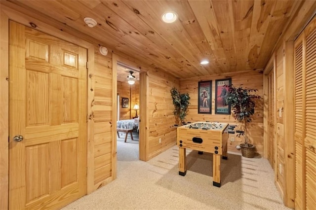 rec room featuring wood ceiling, light carpet, wood walls, and recessed lighting