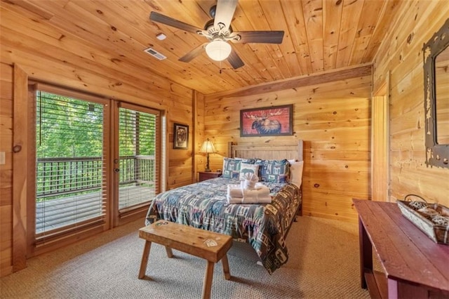 bedroom featuring wooden ceiling, access to exterior, wooden walls, and carpet