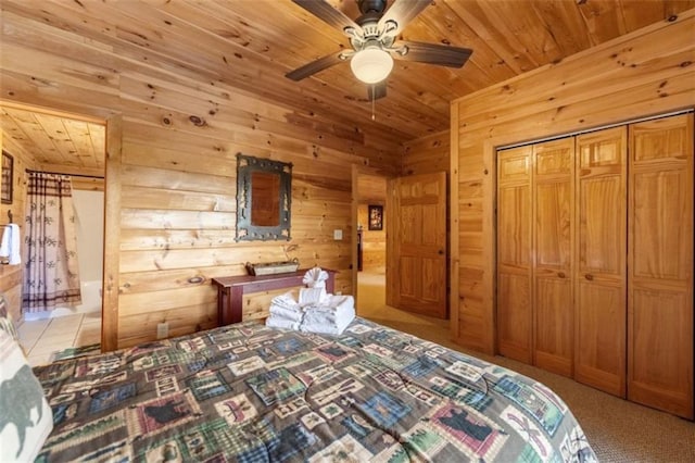 carpeted bedroom with wooden ceiling, ceiling fan, wooden walls, and a closet