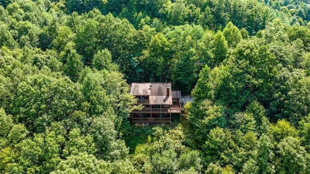 drone / aerial view featuring a wooded view