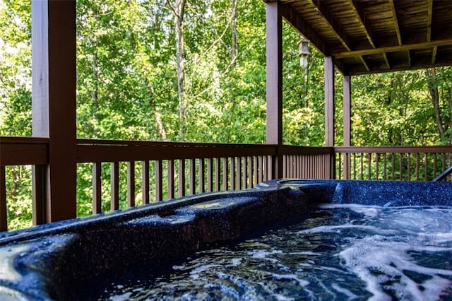 wooden deck featuring a hot tub