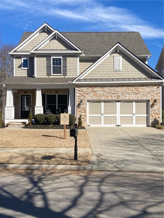 craftsman house featuring a porch and a garage