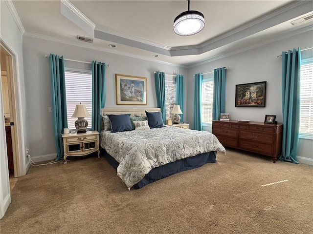 bedroom featuring a tray ceiling, crown molding, light colored carpet, and visible vents