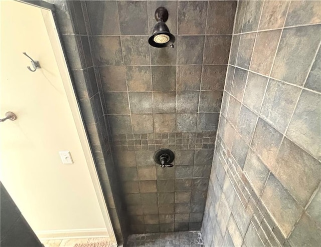 full bath with a tile shower