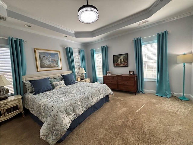 carpeted bedroom with visible vents, a raised ceiling, baseboards, and ornamental molding