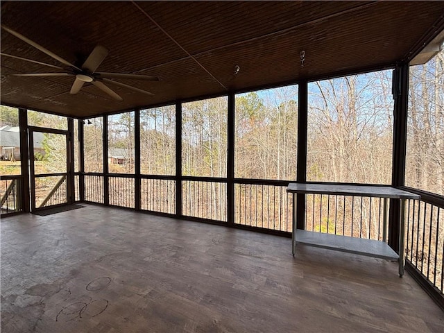 unfurnished sunroom featuring ceiling fan