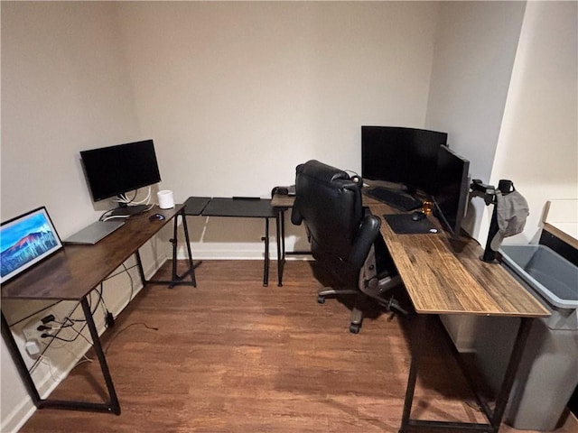 home office with baseboards and wood finished floors