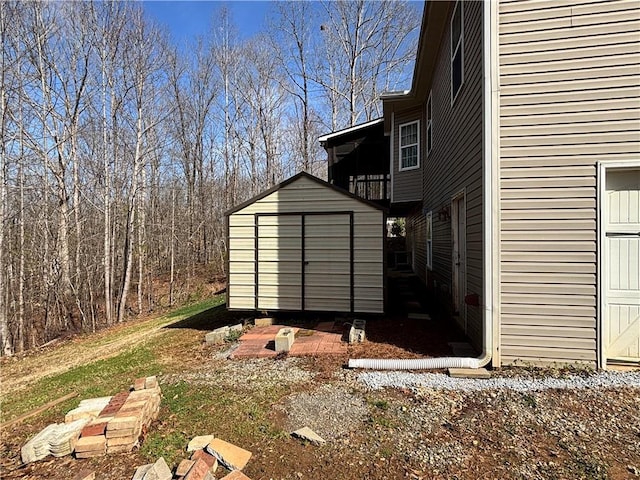 exterior space featuring an outbuilding and a shed