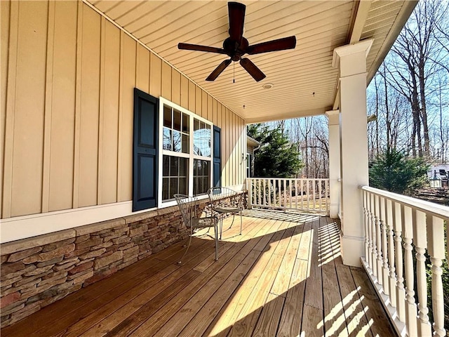 wooden deck with covered porch and a ceiling fan