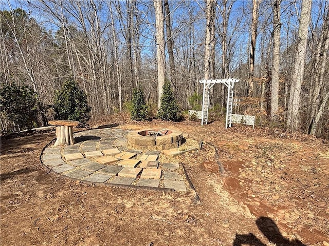 view of yard featuring a patio area and a fire pit