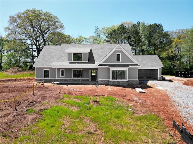 492 Nunnally Farm Rd, Monroe, GA 30655 - view of front of home featuring gravel driveway, covered porch, and an attached garage