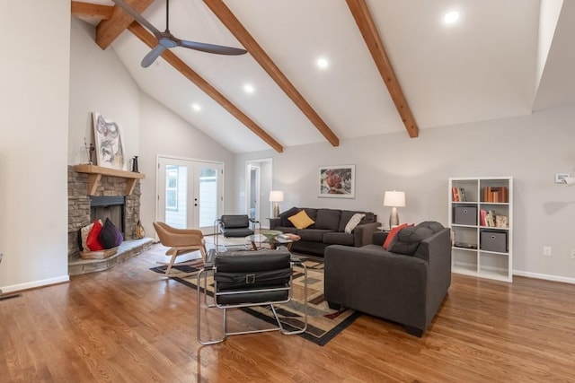 living room with a stone fireplace, beam ceiling, high vaulted ceiling, ceiling fan, and wood-type flooring