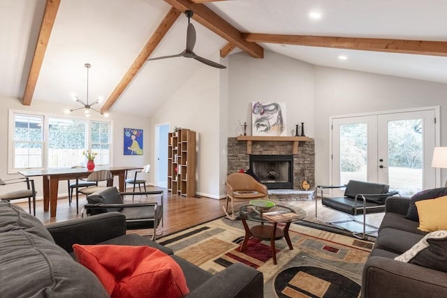 living room with hardwood / wood-style flooring, beamed ceiling, a wealth of natural light, and a fireplace