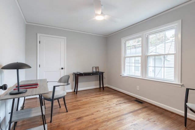 office with ornamental molding, light hardwood / wood-style flooring, and ceiling fan