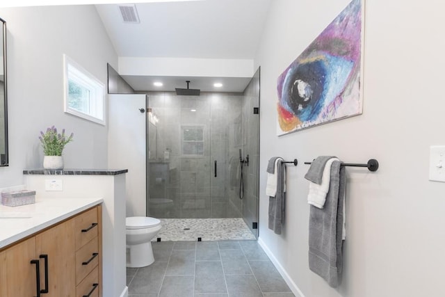 bathroom featuring tile patterned flooring, walk in shower, toilet, and vanity