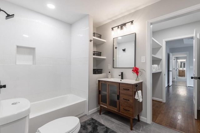 full bathroom featuring vanity, toilet, hardwood / wood-style flooring, and  shower combination