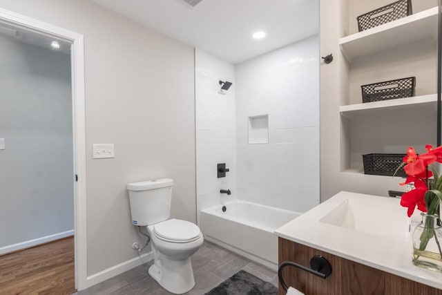 full bathroom with toilet, hardwood / wood-style floors, vanity, and  shower combination