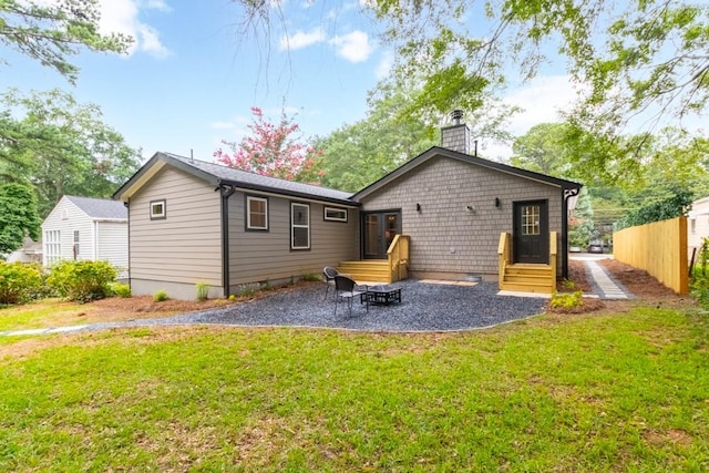 back of house with a yard and a patio