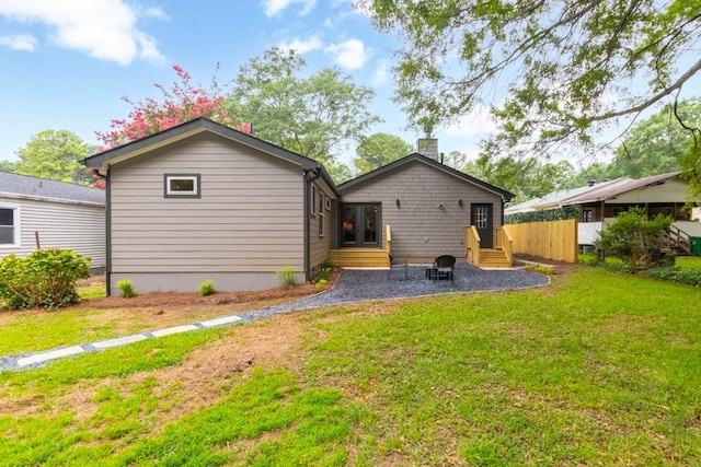 rear view of property with a yard