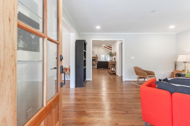 living room featuring ornamental molding and wood-type flooring