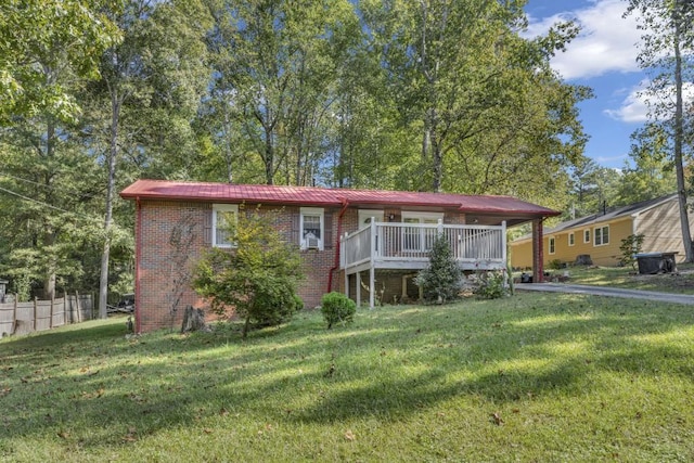 view of front of house with a front yard and a wooden deck