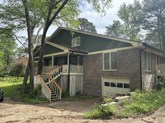 2256 Mack Rd, Douglasville, GA 30135 - view of front of property with brick siding, an attached garage, driveway, stairway, and a porch