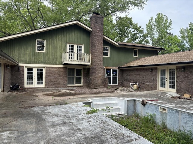 2256 Mack Rd, Douglasville, GA 30135 - back of property with french doors, a chimney, brick siding, and a balcony