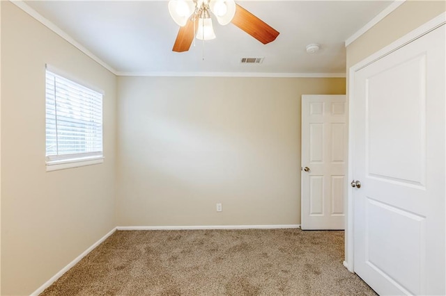 unfurnished room featuring ornamental molding, light colored carpet, and ceiling fan