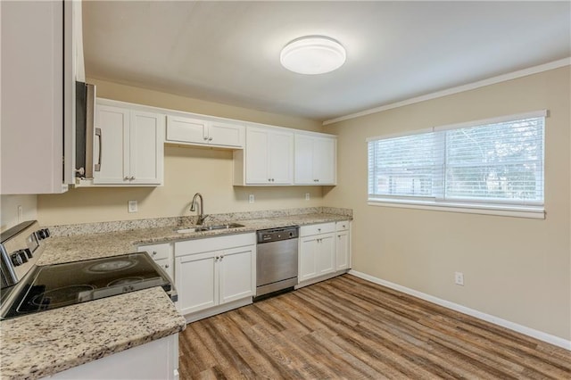 kitchen with sink, light wood-type flooring, stainless steel appliances, light stone countertops, and white cabinets