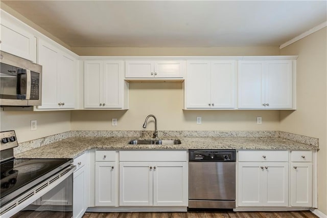 kitchen with sink, stainless steel appliances, and white cabinets