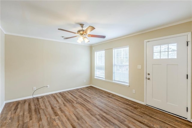 entrance foyer featuring ornamental molding, ceiling fan, and light wood-type flooring