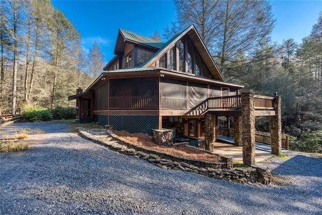 139 Wall St, Ellijay, GA 30540 - view of side of home featuring metal roof, a wooden deck, and a sunroom