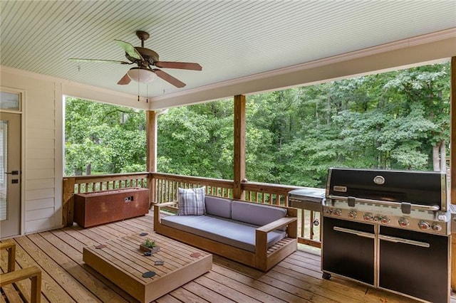 deck featuring ceiling fan and a grill