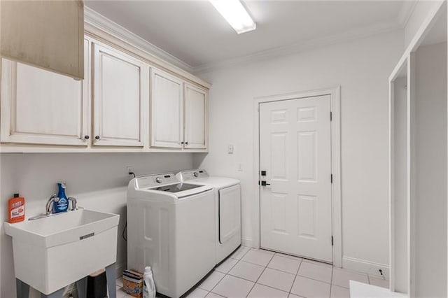 washroom with cabinets, light tile patterned flooring, sink, crown molding, and washer and clothes dryer