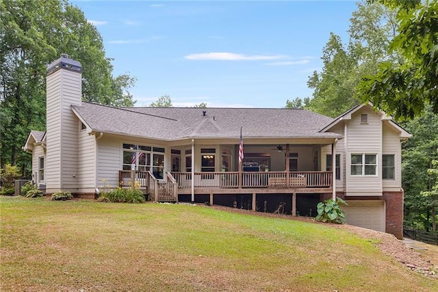 rear view of property with a yard, a porch, ceiling fan, and a garage