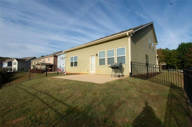 back of property with a patio area and a lawn