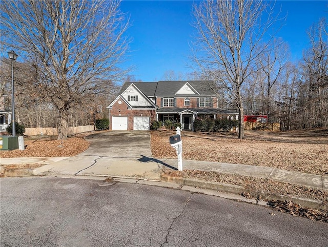 view of front of property with brick siding, driveway, and a garage