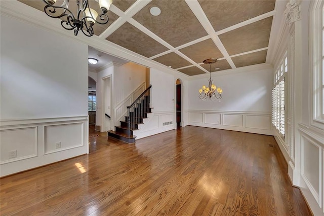 4853 Stonehall Pl, Atlanta, GA 30339 - unfurnished room with a chandelier, a decorative wall, arched walkways, coffered ceiling, and crown molding