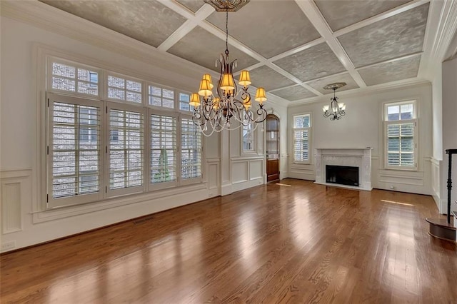 4853 Stonehall Pl, Atlanta, GA 30339 - unfurnished living room with a chandelier, a decorative wall, coffered ceiling, a high end fireplace, and wood finished floors