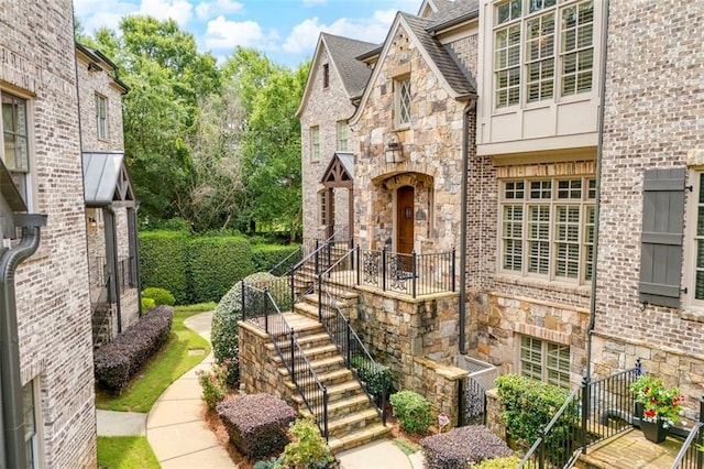 4853 Stonehall Pl, Atlanta, GA 30339 - view of exterior entry featuring stone siding, a shingled roof, and brick siding