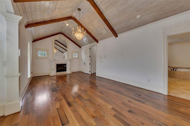 4853 Stonehall Pl, Atlanta, GA 30339 - unfurnished living room with hardwood / wood-style flooring, a chandelier, wooden ceiling, a large fireplace, and ornate columns