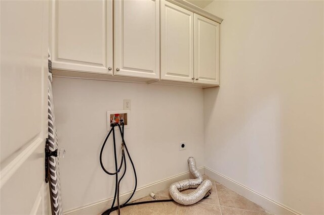 4853 Stonehall Pl, Atlanta, GA 30339 - laundry room with cabinet space, washer hookup, hookup for an electric dryer, tile patterned flooring, and baseboards