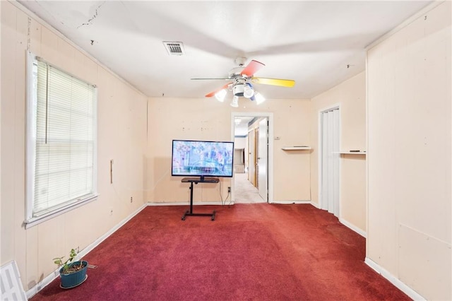 spare room featuring visible vents, carpet flooring, baseboards, and ceiling fan