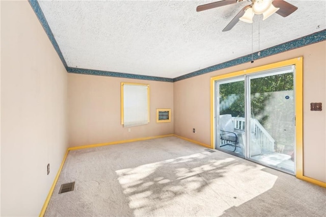 unfurnished room featuring carpet floors, a ceiling fan, baseboards, and visible vents