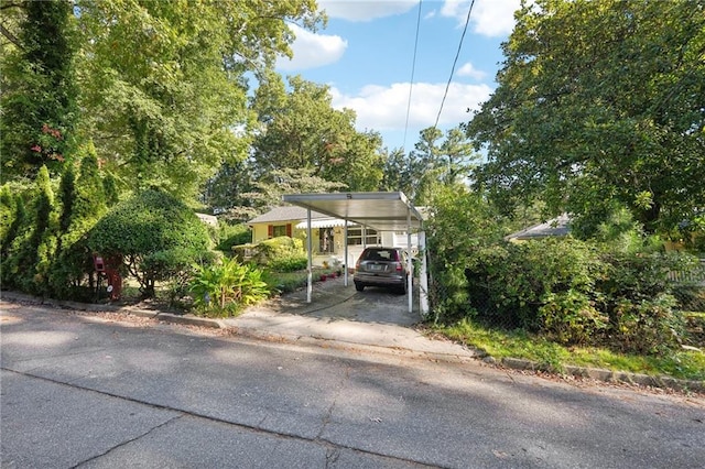 view of parking / parking lot featuring driveway and a carport