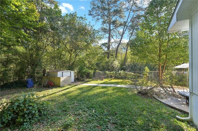 view of yard with a fenced backyard, an outdoor structure, and a shed