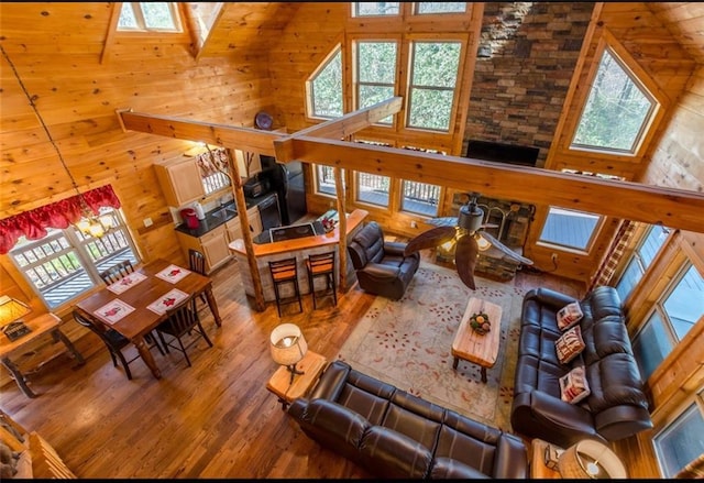 living room featuring a wealth of natural light and high vaulted ceiling